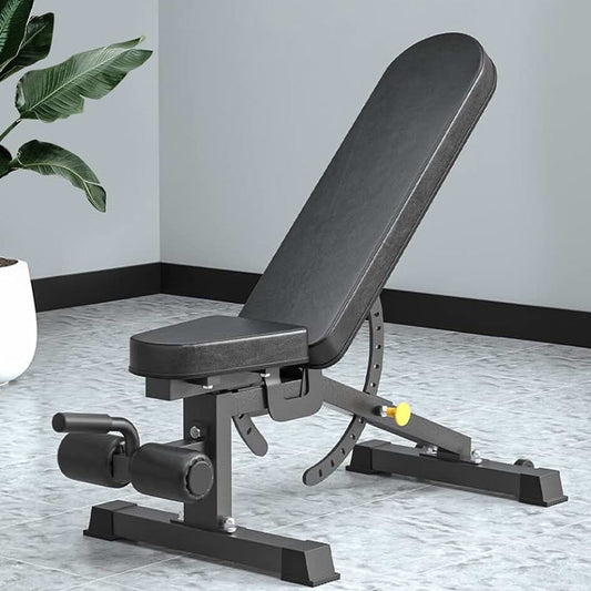 Black adjustable weight bench in a room with a plant and light-colored floor.
