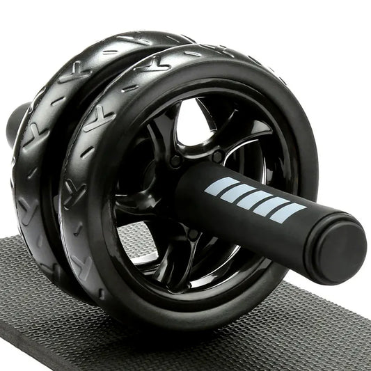 Black ab roller on a gray mat with a white background