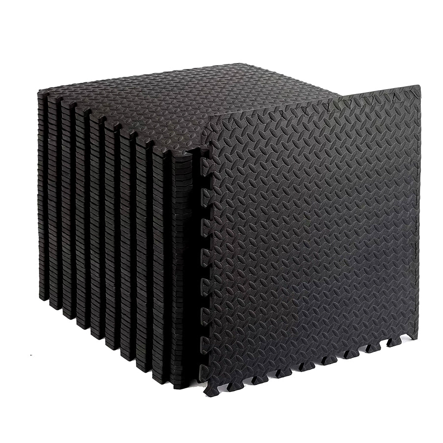 Stack of black foam puzzle mats on a white background