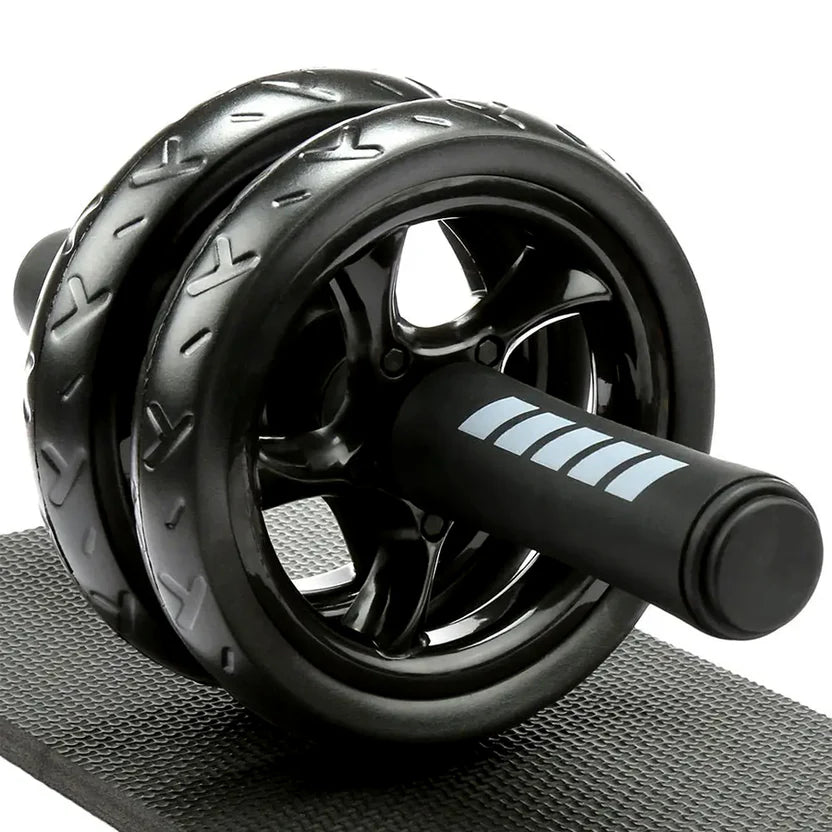 Black ab roller on a gray mat with a white background