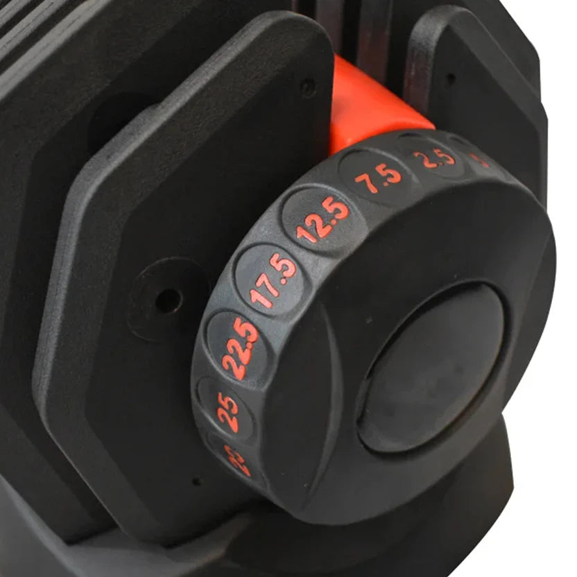Close-up of a black weight plate with red measurement markings on a white background