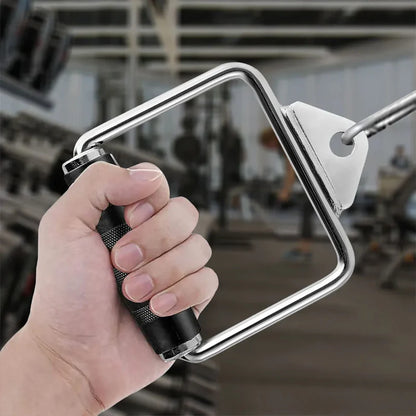 Hand holding a metal hand saw with a blurred gym background