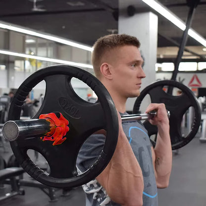Man lifting a barbell with weight plates in a gym setting