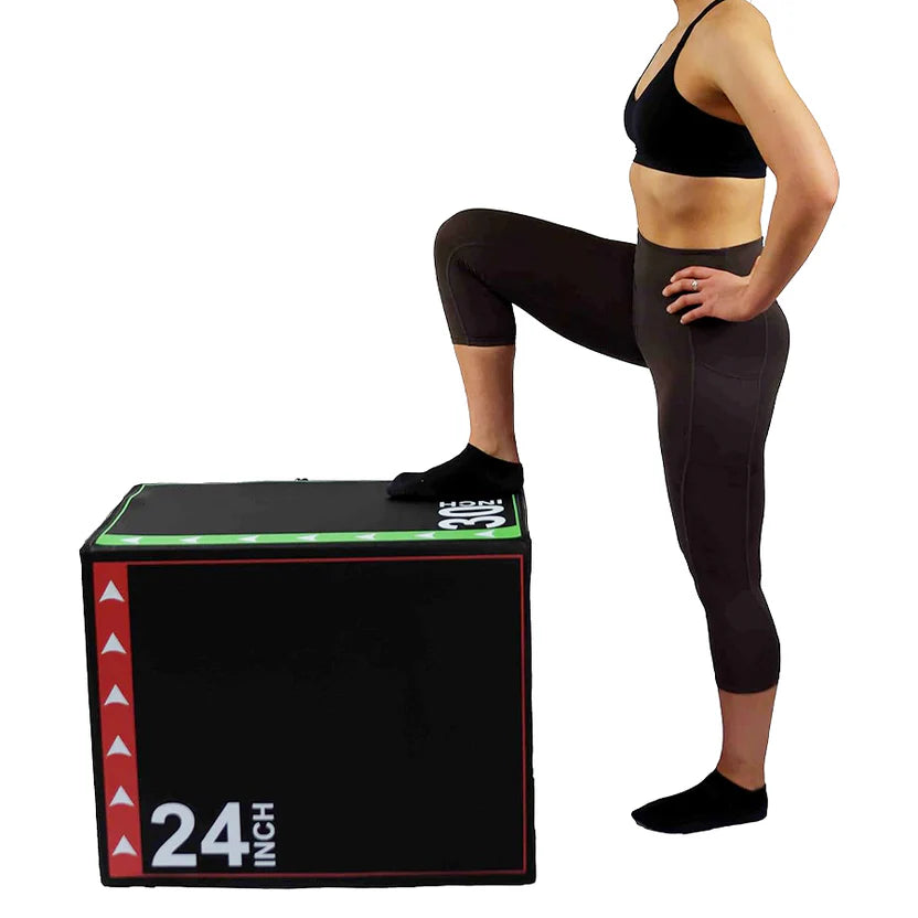 Woman in athletic wear standing on a black exercise box with '24' and '30' labeled on it.