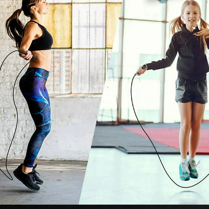 Two people, a woman and a girl, exercising with jump ropes indoors.