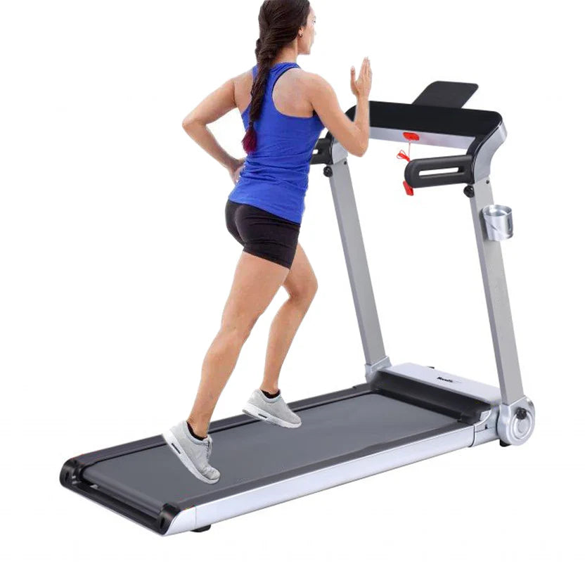 Woman using a treadmill on a white background