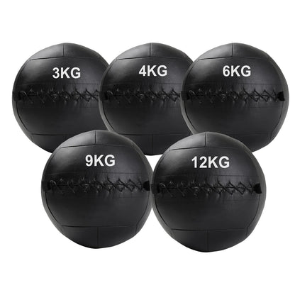 Five black weighted medicine balls with weight markings on a white background